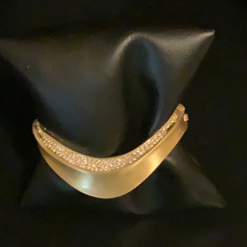 Unique designer bracelet by Vince Camuto.  Gold tone with simulated diamonds.